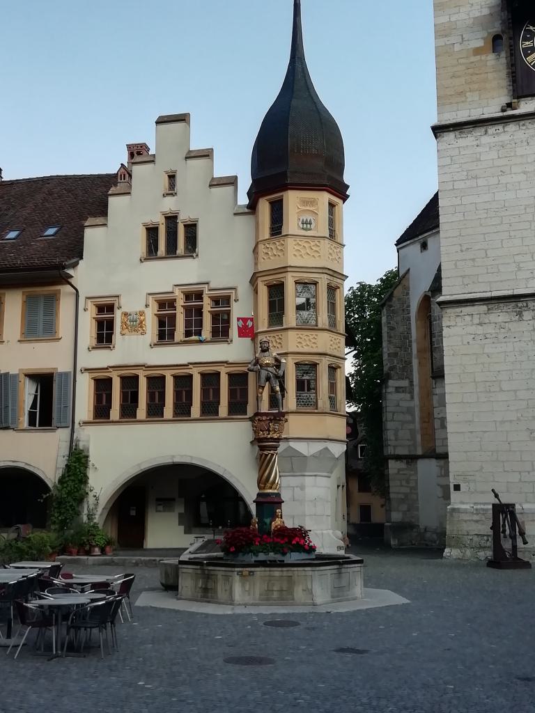 Rieen con la fuente del caballero, la llamada Venner-brunnen. A la derecha los badajos de las campanas de la iglesia